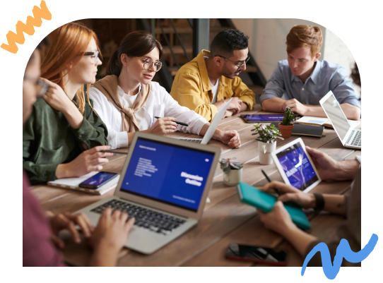 A group of people working on their laptops together