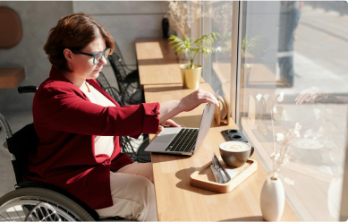 A woman in a wheelchair working at her desk