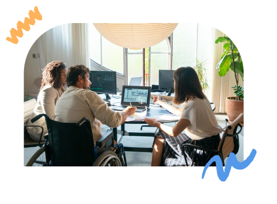 A photo of individuals in wheelchairs in the office working